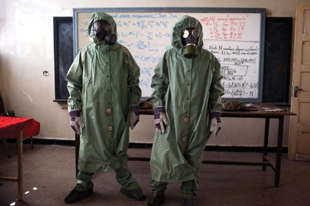 Men in chemical suits and gasmasks