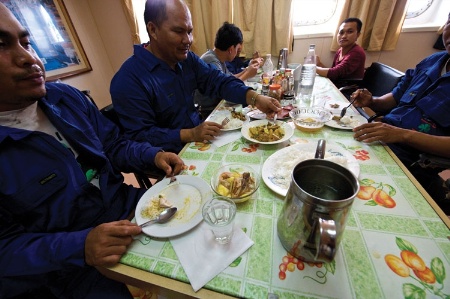 Seafarers eating on ship