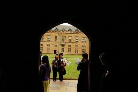 University graduate holding flowers