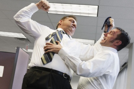 Businessman assaulting colleague in office