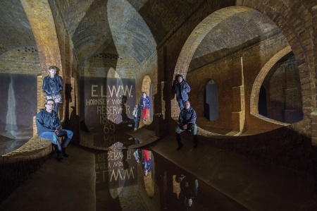 Group of people in sewer tunnels