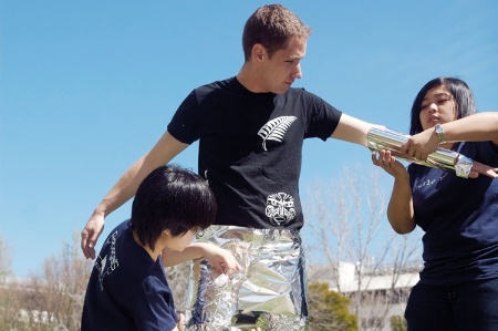 Man being wrapped in tin foil