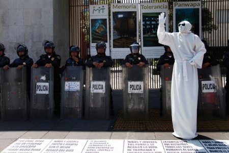 Mexican mime artist and riot police