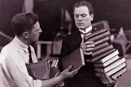 Man carrying pile of books