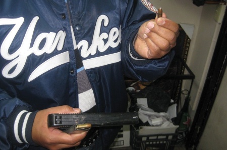 Man holding pistol and bullet