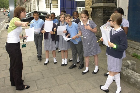 Teacher speaking to primary school students