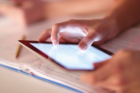 Person pinching-to-zoom on touchscreen tablet device