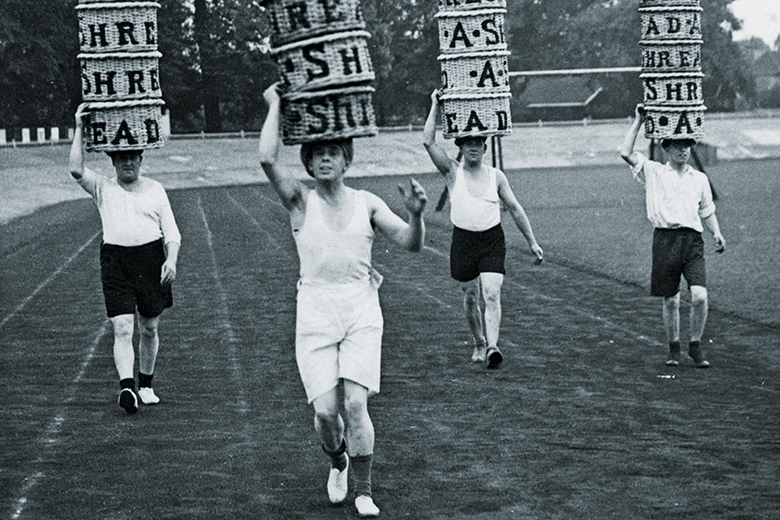 Men racing with baskets on their heads