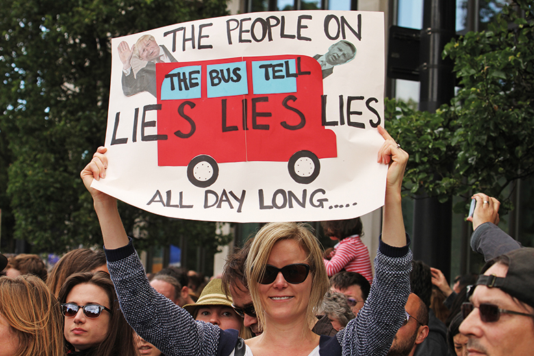 Protester holds up sign