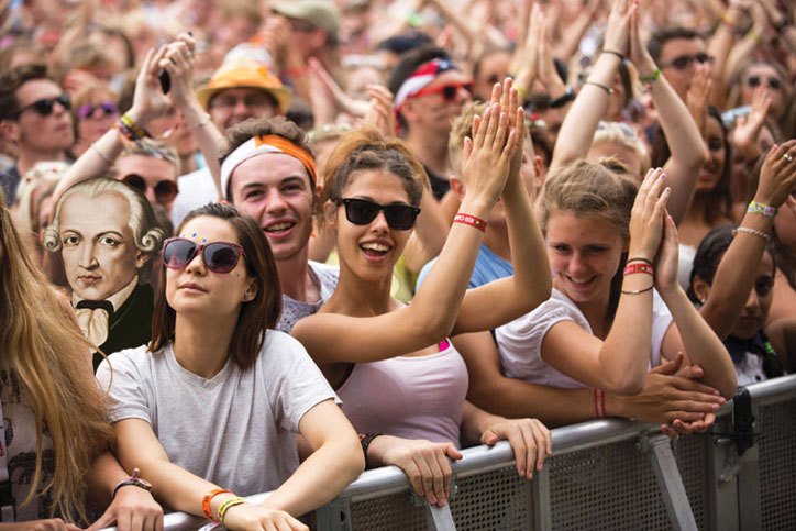 Crowd of people applauding at concert