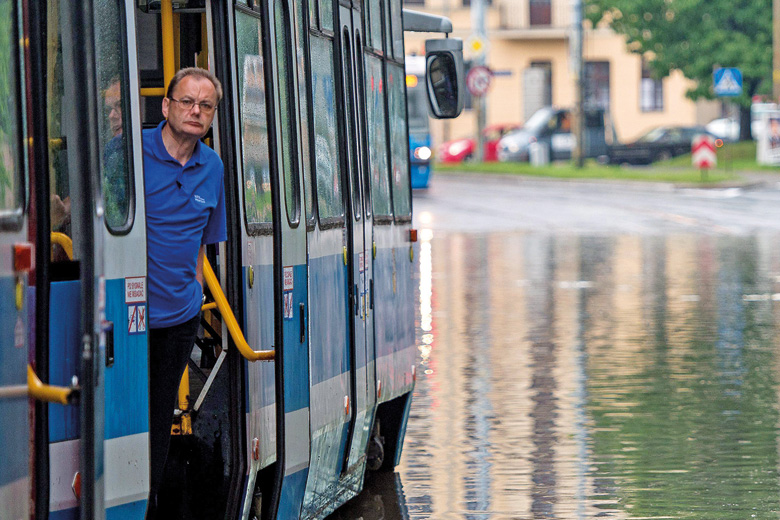 Man on tram stuck on flooded street, Wroclaw, Poland