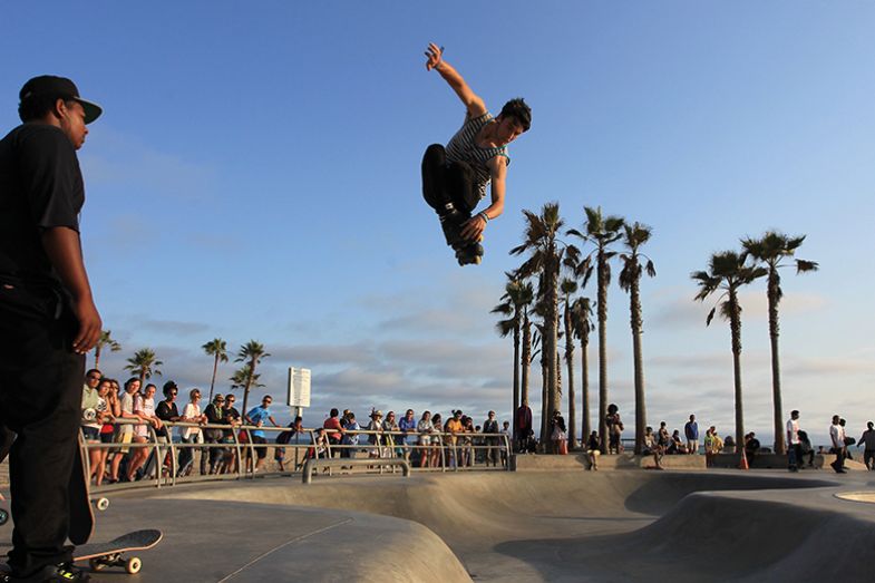 Spectators watch skateboarders do tricks