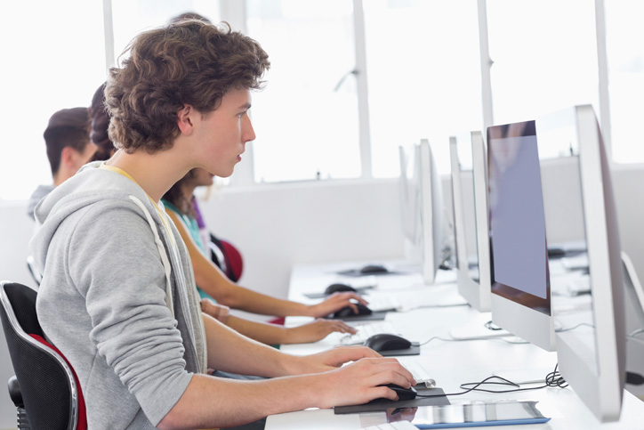 Students working on Apple iMac computers