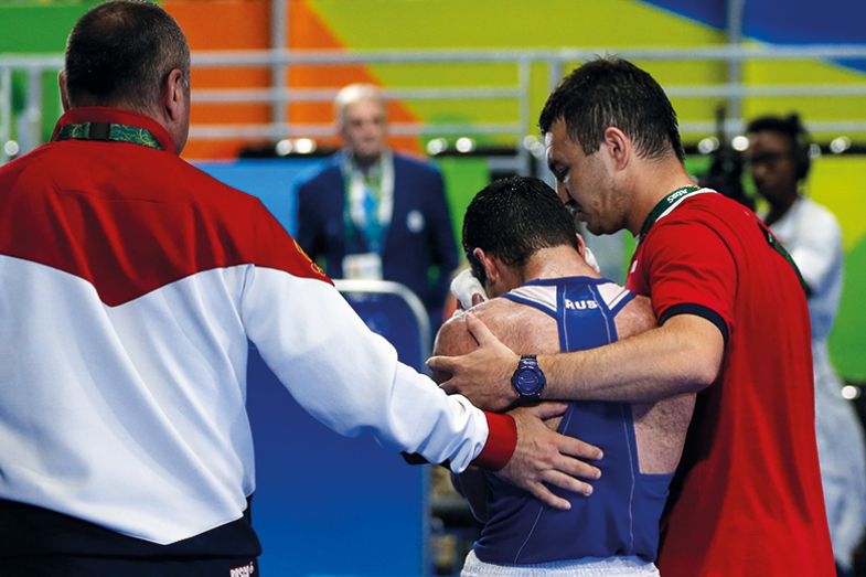 Coach comforts athlete