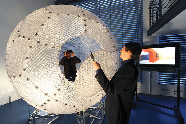 The research associate of the special research field computational neuroscience Thorsten Kluss (l) takes part in an experiment at the computational neuroscience department of the university in Bremen, Germany