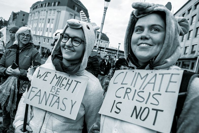 climate protesters wearing unicorn onesies