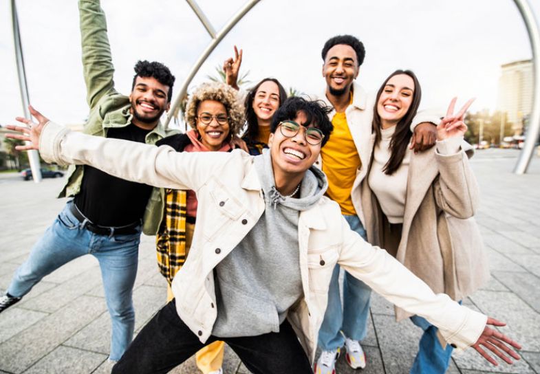 A group of international students smiling and posing for the camera