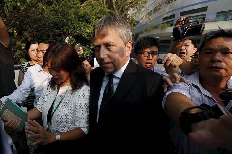 Peter Mathieson surrounded by a group of students in Hong Kong