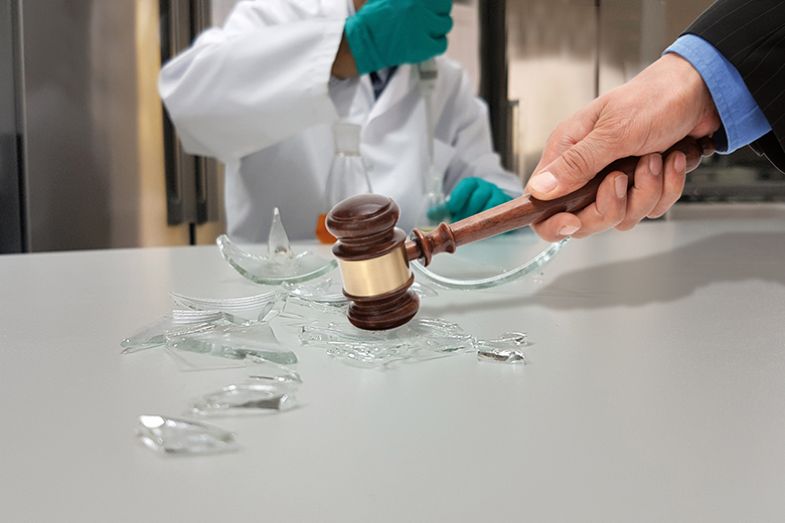 Smashing glass beaker with gavel