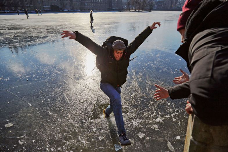 ice skater walking through thin ice on the frozen Hofvijver outside the parliament 