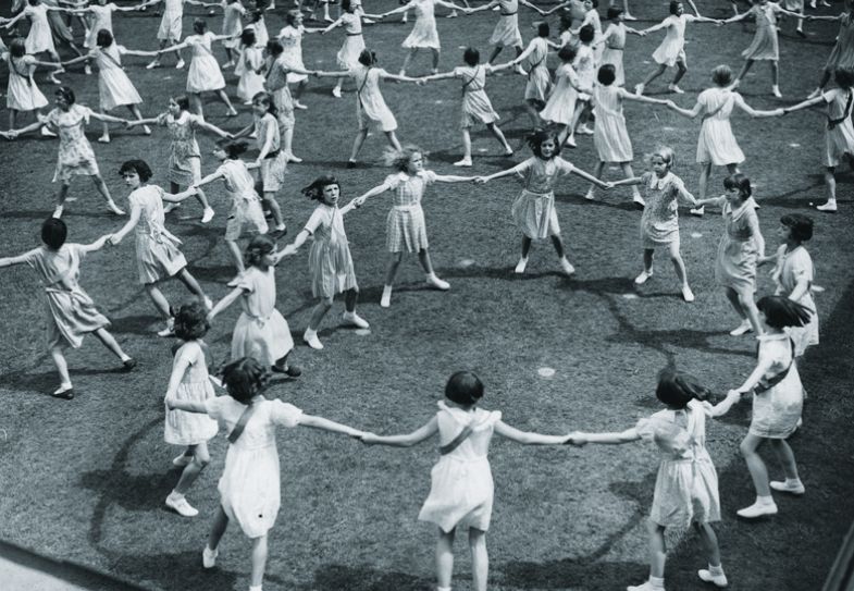 Schoolgirls of Plaistow Municipal Secondary School in West Ham, London, performing country dances during celebrations to illustrate Play by playground rules