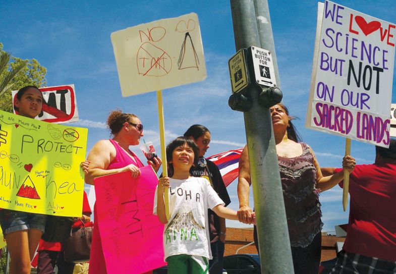 Activists protest a planned telescope for Moana Kea on the Big Island of Hawaii in front of the Thirty Meter Telescope (TMT)  as mentioned in the copy.