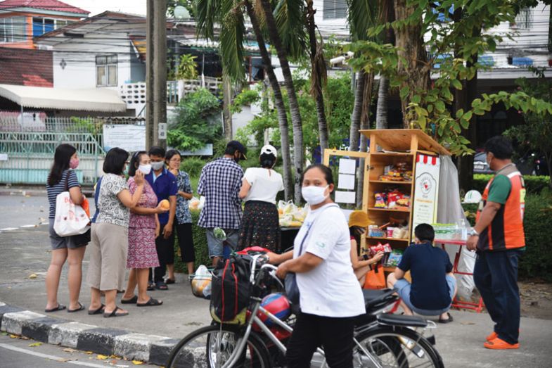 People queue to receive relief supplies from the food pantry during the Coronavirus crisis