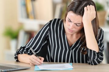 Concerned woman signs document