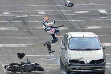 Car hits human dummy on scooter