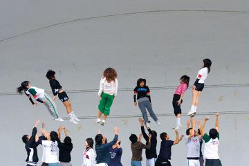 Chinese students throwing other students in air