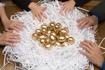 Colleagues around a nest of gold eggs