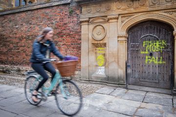 The Gate of Honour at Gonville & Caius College, Cambridge, spray painted with the with words 'Eugenics is genocide. Fisher must fall' by activists calling for the college to remove its memorial window to Ronald Fisher