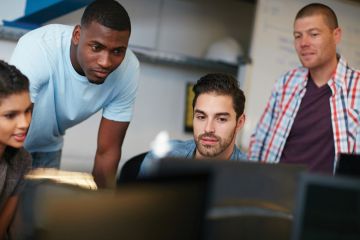 Group of students looking at computer monitor