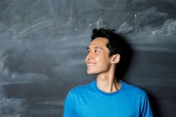 Student in front of blackboard