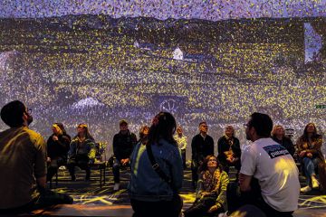 Audience watching an Immersive experience to illustrate a better, faster way to find survey participants