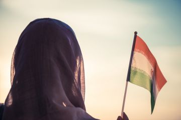 Woman waves Iranian flag