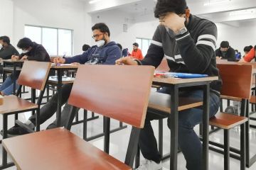 Medical students writing examination paper in mask maintaining social distancing at Radheshwam Medical College,Lucknow, UP, India.