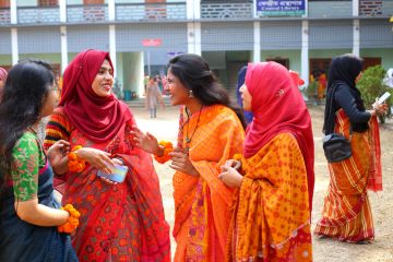 A group of adult students in traditional dress participate in the spring festival celebration.