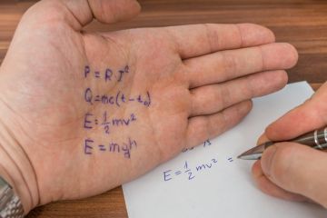 A student in an exam copies from things written on their hand