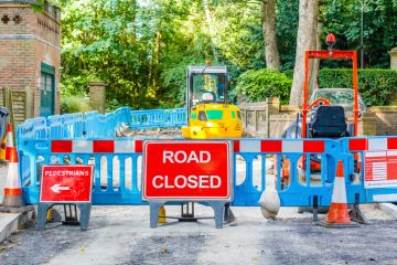 In front of roadworks a sign says 'Road closed'