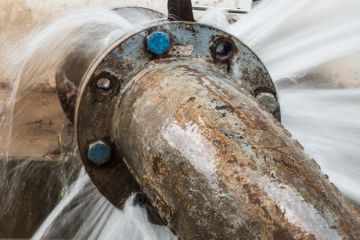 A pipleine with water leaking out of it, symbolising the loss of women from engineering