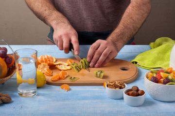 Man cutting fruit