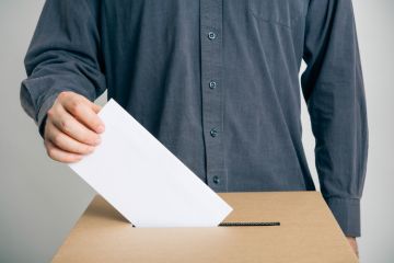 Man putting vote in ballot box