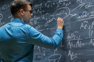 A mathematician works on the blackboard