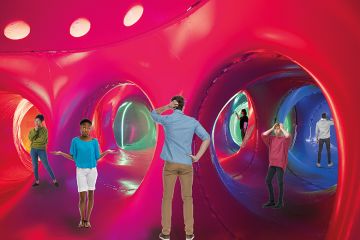 Montage of people looking puzzled at the various entrances inside an inflatable Luminaria creation