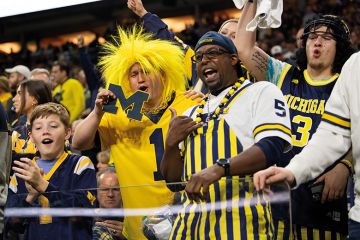 Michigan Wolverines fans celebrate in the stands during the Big 10 Championship to illustrate Change to image rights law brings a revolution in US college sports