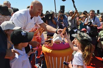 Celebrity chief Matt Moran cuts pieces of a giant cake of the Sydney Opera House as the world heritage-listed building celebrates its 40th birthday on October 20, 2013