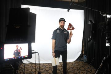 James Hinchcliffe holds a poop emoji while filming on a screen to illustrate Academics despair as ChatGPT-written essays swamp marking season