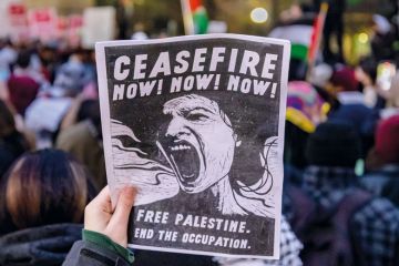 A pro-Palestinian protester carries a sign in Midtown Manhattan during a protest calling for a ceasefire between Israel and Hamas to illustrate US campuses try tolerance training to defuse Palestine protests