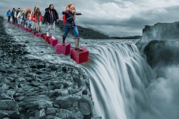 Montage of a group stepping on cubes leading to a waterfall 